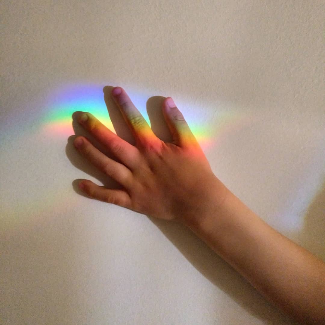 A rainbow over a hand